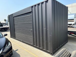 20ft Used Shipping Container – Matte Black w/ 12’ Side Roll-Up Door